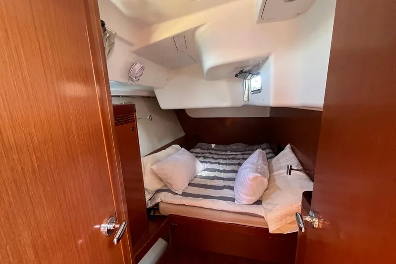Slide: The Image of Cozy cabin interior of 2011 Beneteau Oceanis 54 yacht with striped bedding. - 41