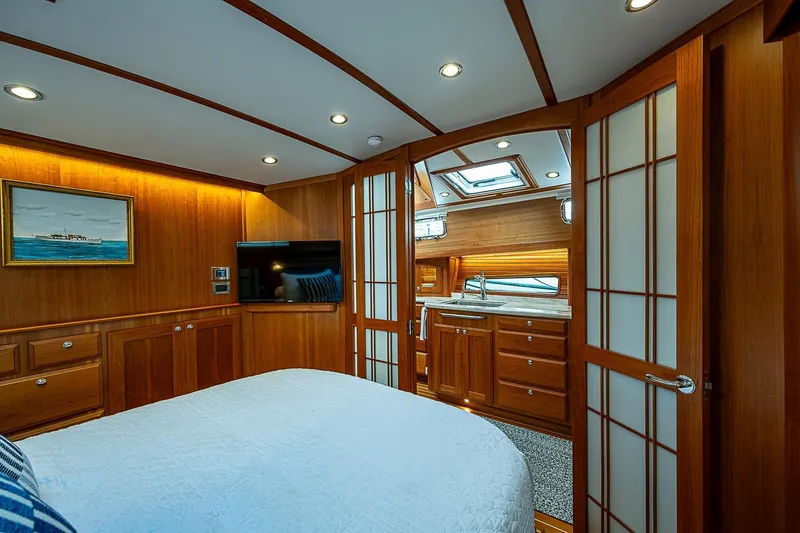 Slide: The Image of Luxurious 2020 Sabre 48 Salon Express yacht interior with wood paneling and modern amenities. - 16