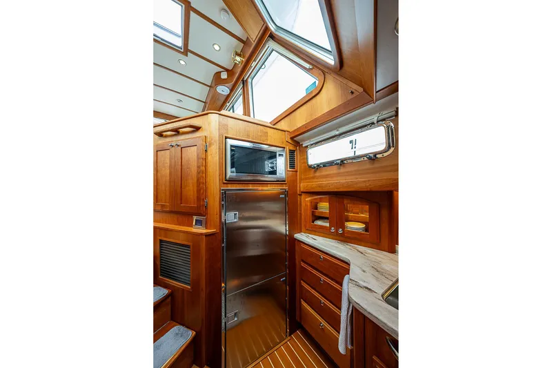 Slide: The Image of Luxurious interior of 2020 Sabre 48 Salon Express yacht with wooden cabinetry and stainless steel appliances. - 13