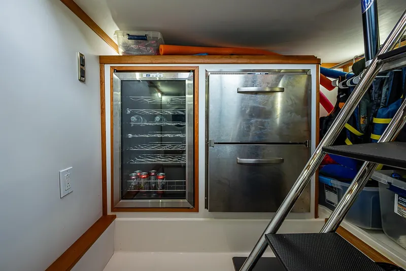Slide: The Image of Interior of 2020 Sabre 48 Salon Express with fridge and storage area. - 9