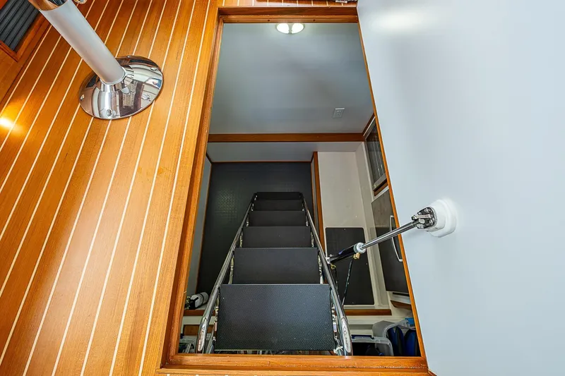Slide: The Image of Interior stairs of 2020 Sabre 48 Salon Express yacht with wooden paneling. - 8