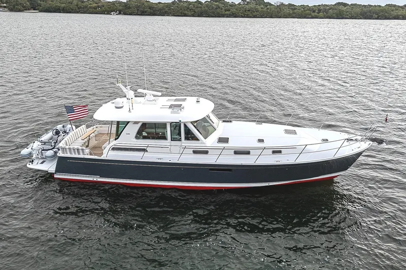Slide: The Image of 2020 Sabre 48 Salon Express yacht on calm water, side view. - 1