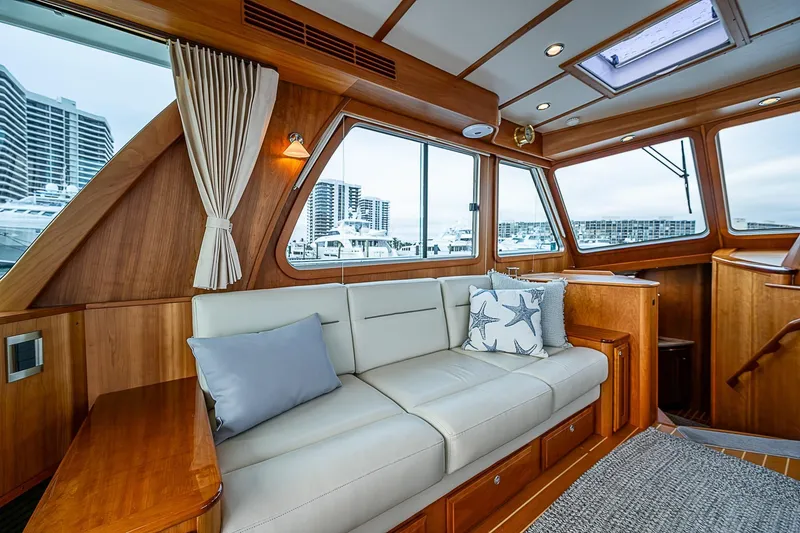 Slide: The Image of Luxurious interior of 2020 Sabre 48 Salon Express yacht with plush seating and elegant wood finish. - 6