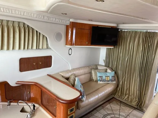 Slide: The Image of Interior of a 2001 Sea Ray 400 Sedan Bridge with leather sofa and TV. - 13
