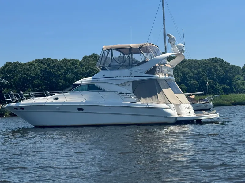 Slide: The Image of 2001 Sea Ray 400 Sedan Bridge on calm water. - 1