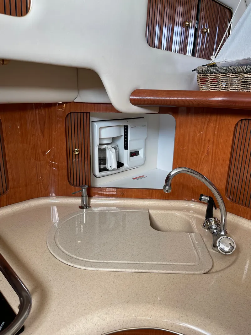 Slide: The Image of The galley of a 2001 Sea Ray 400 Sedan Bridge with a sink and coffee maker. - 10