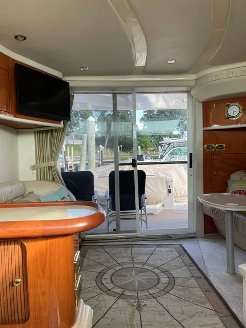 Slide: The Image of Interior of a 2001 Sea Ray 400 Sedan Bridge with elegant furnishings and large windows. - 11