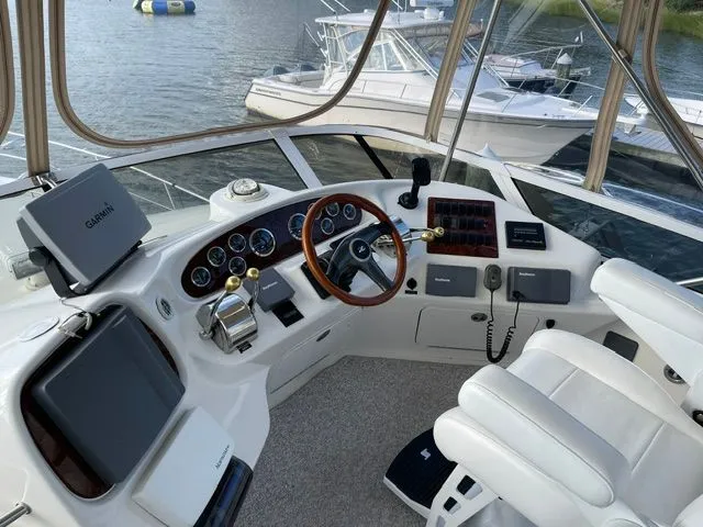 Slide: The Image of The image shows the cockpit of a 2001 Sea Ray 400 Sedan Bridge with modern navigation equipment. - 9