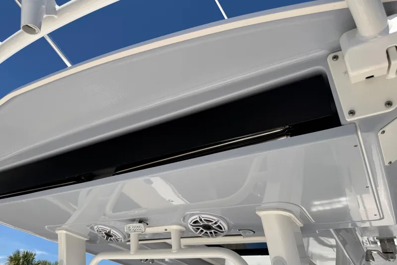 Slide: The Image of 2023 Robalo R360 Center Console boat's overhead view with speakers and blue sky. - 15