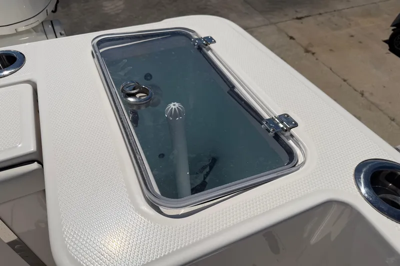 Slide: The Image of 2023 Robalo R360 Center Console livewell with transparent lid and textured surface. - 11