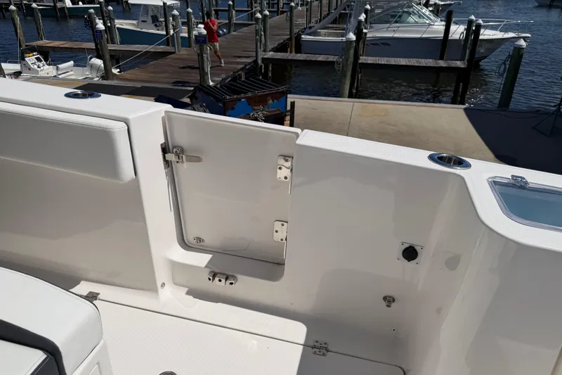 Slide: The Image of 2023 Robalo R360 Center Console boat at dock, featuring open side door. - 9