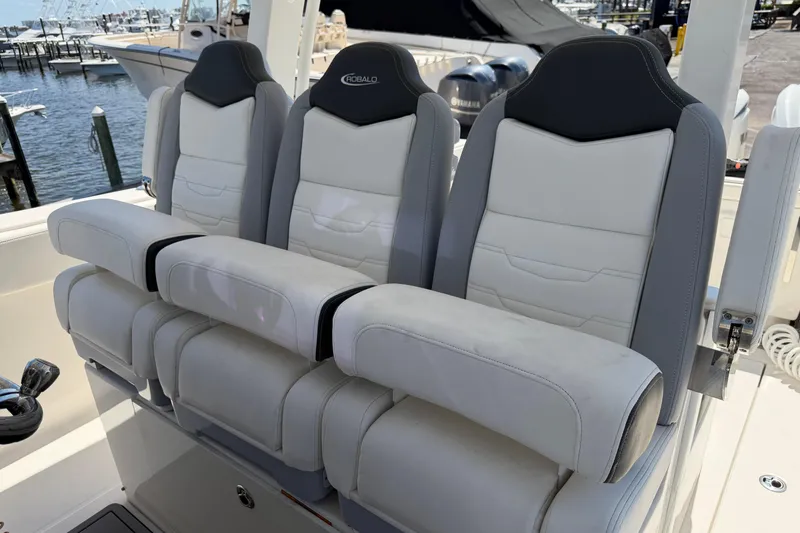 Slide: The Image of 2023 Robalo R360 Center Console boat seats at marina, featuring plush, ergonomic design. - 34