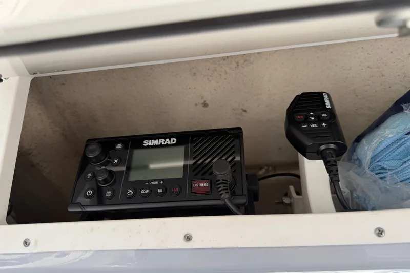 Slide: The Image of Simrad marine radio in 2023 Robalo R360 Center Console boat compartment. - 27