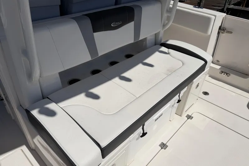 Slide: The Image of 2023 Robalo R360 Center Console boat seating area with integrated storage and cup holders. - 14
