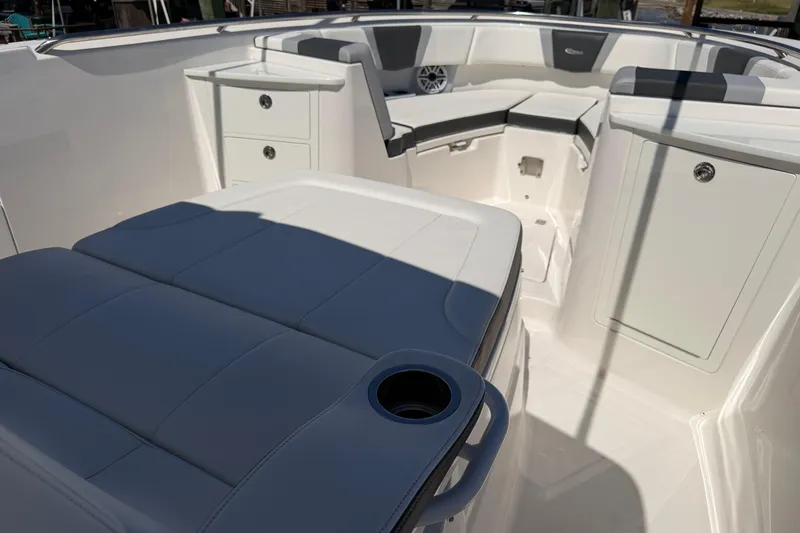 Slide: The Image of 2023 Robalo R360 Center Console boat interior with cushioned seating and storage compartments. - 39