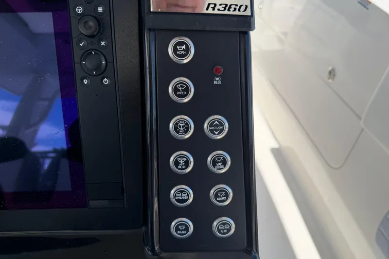 Slide: The Image of Control panel of 2023 Robalo R360 Center Console boat with various function buttons. - 36