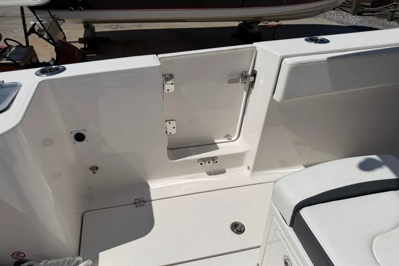 Slide: The Image of 2023 Robalo R360 Center Console boat interior with open hatch and seating area. - 8