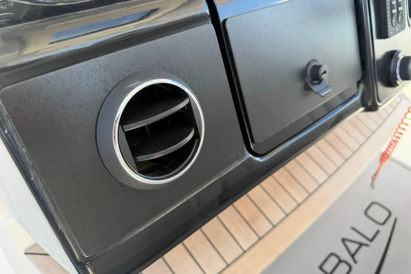 Slide: The Image of 2023 Robalo R360 Center Console dashboard with air vent and storage compartment. - 32