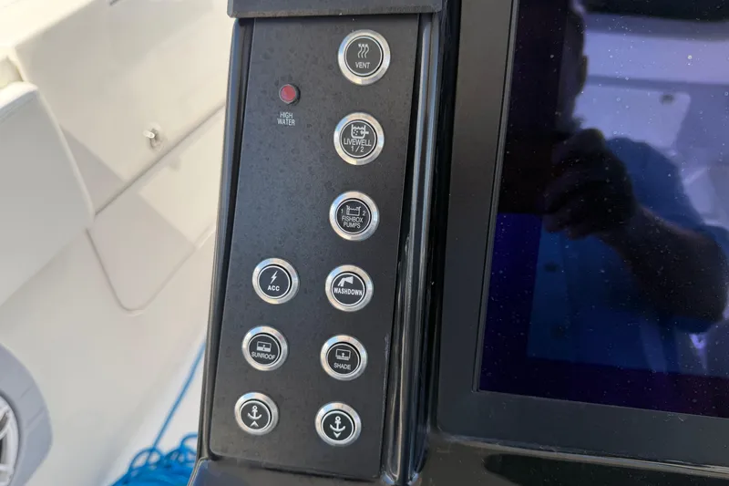 Slide: The Image of Control panel of 2023 Robalo R360 Center Console boat with various function buttons. - 37