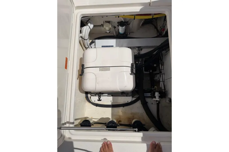 Slide: The Image of 2023 Robalo R360 Center Console boat compartment with equipment and wiring. - 13
