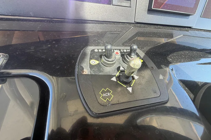 Slide: The Image of Control panel of 2023 Robalo R360 Center Console boat with joystick and buttons. - 23