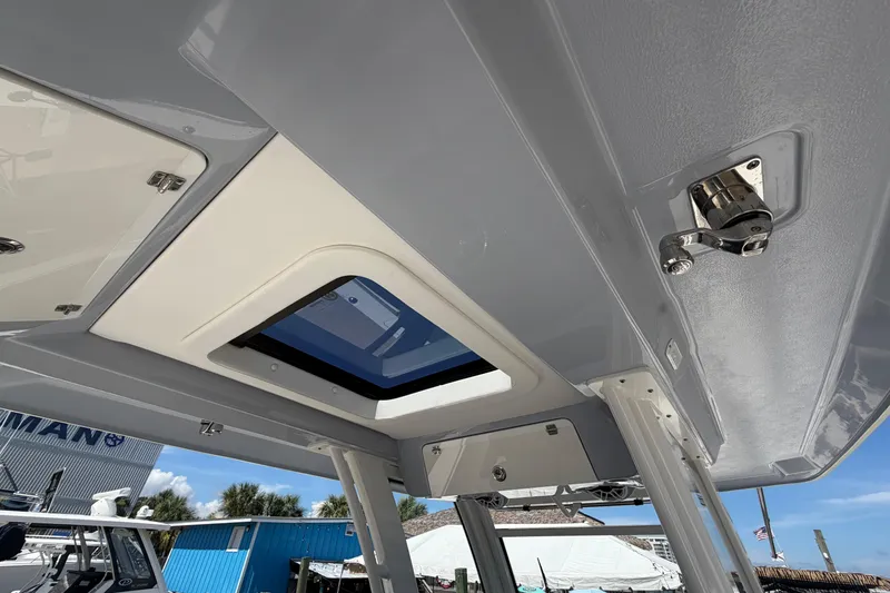 Slide: The Image of 2023 Robalo R360 Center Console boat roof with hatch and hardware details. - 17