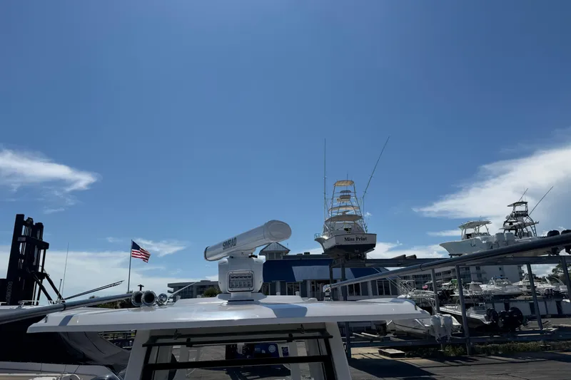 Slide: The Image of 2023 Robalo R360 Center Console boat docked under clear blue sky. - 43