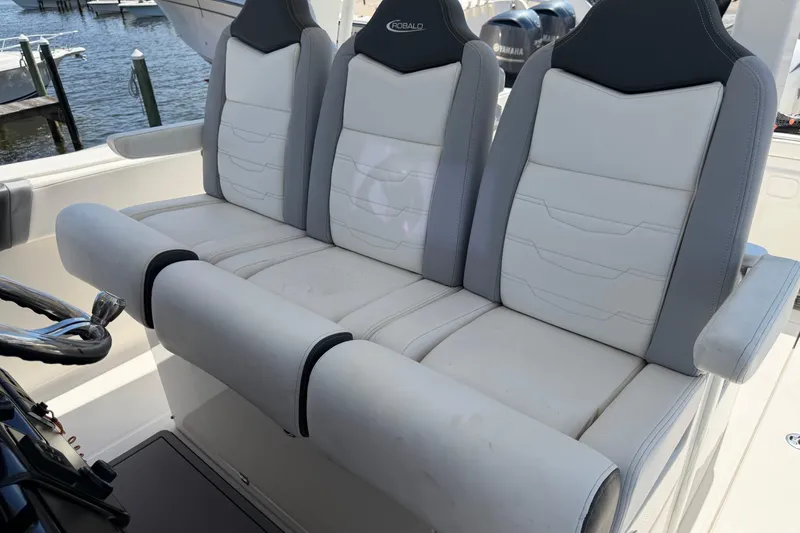 Slide: The Image of 2023 Robalo R360 Center Console boat seating with luxurious white and gray upholstery. - 35
