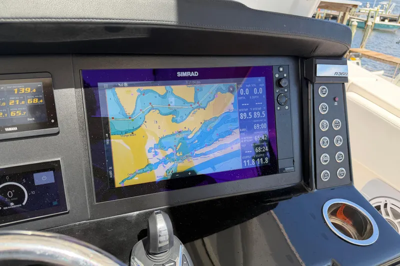Slide: The Image of 2023 Robalo R360 Center Console with Simrad navigation display at helm. - 30