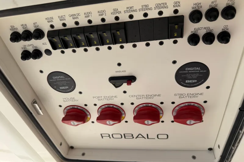 Slide: The Image of Control panel of 2023 Robalo R360 Center Console boat with battery switches and digital displays. - 38