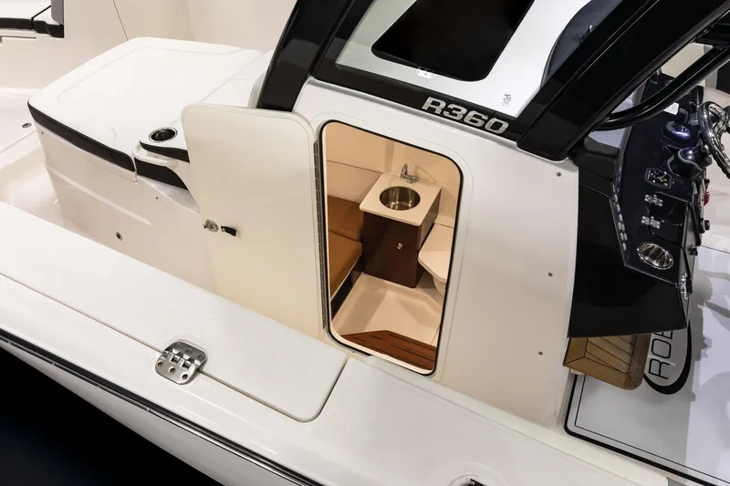 Slide: The Image of 2023 Robalo R360 Center Console boat interior with sink and seating area. - 48