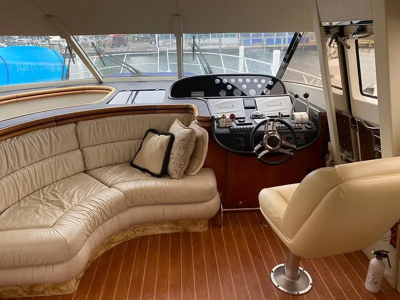 Slide: The Image of Interior of the 1998 Sunseeker Manhattan 62 featuring a sleek helm and comfortable seating. - 19