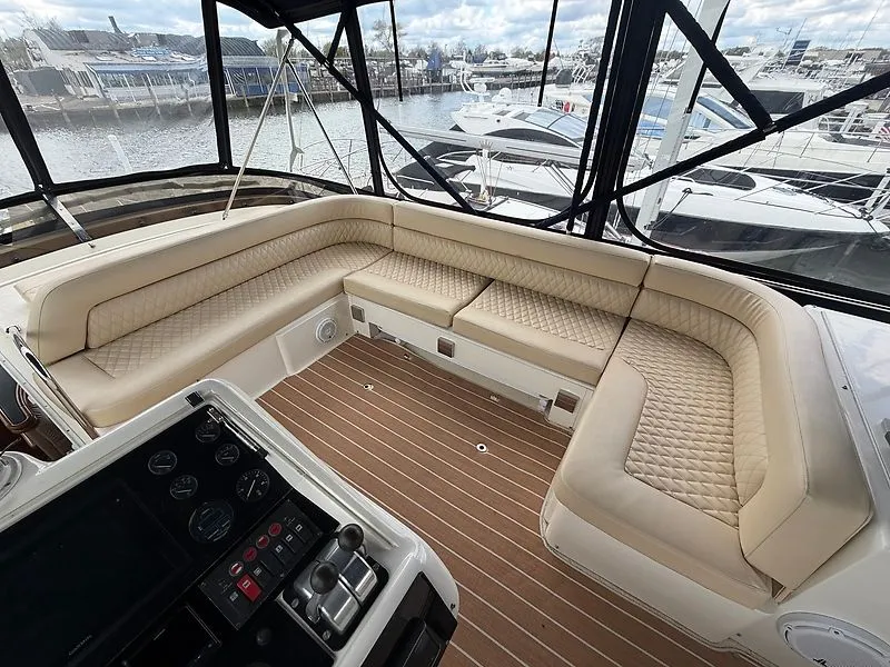 Slide: The Image of The image shows the cockpit of a 1998 Sunseeker Manhattan 62 with beige leather seating. - 12