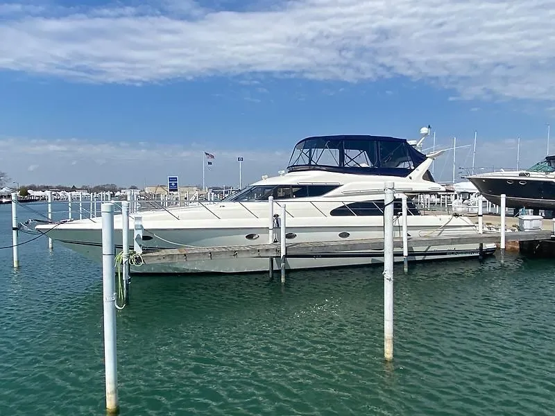 Slide: The Image of 1998 Sunseeker Manhattan 62 docked with a blue sky and calm water. - 7
