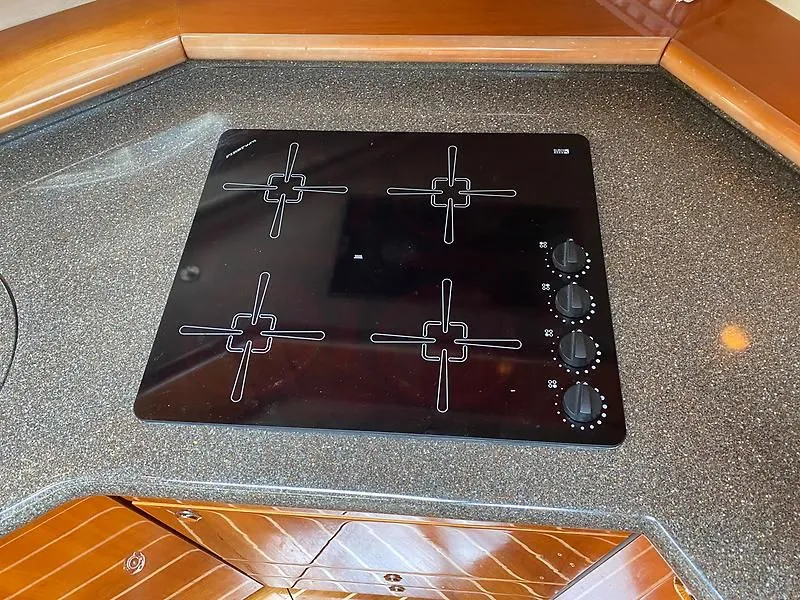 Slide: The Image of The 1998 Sunseeker Manhattan 62 features a modern four-burner cooktop in its kitchen area. - 29