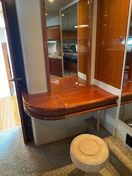 Slide: The Image of Interior of the 1998 Sunseeker Manhattan 62 with wooden furnishings and a round stool. - 35