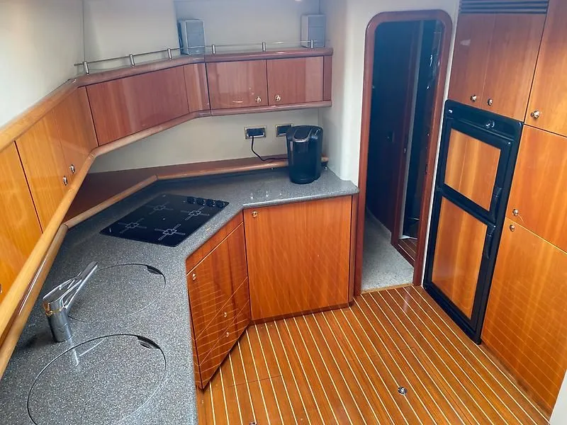 Slide: The Image of The 1998 Sunseeker Manhattan 62's kitchen features elegant wood cabinets and modern appliances. - 3