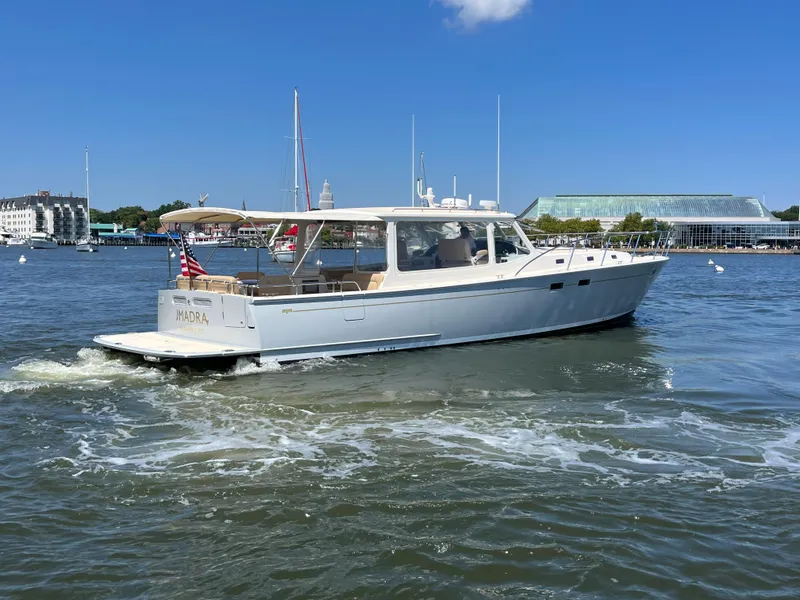 Slide: The Image of 2016 MJM 50z yacht cruising on a sunny day in a harbor. - 1