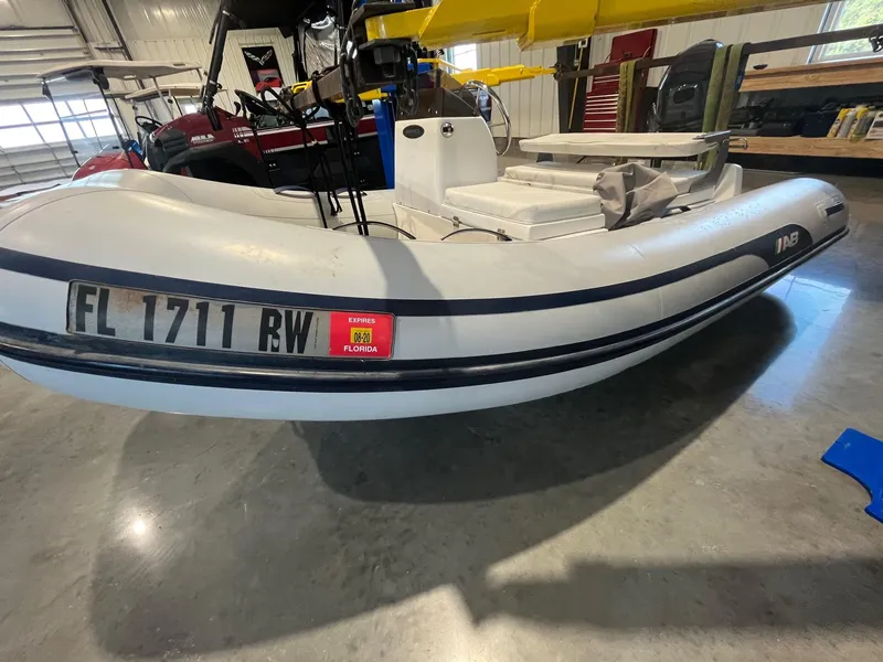 Slide: The Image of White MJM 50z 2016 inflatable boat with Florida registration in a garage setting. - 37