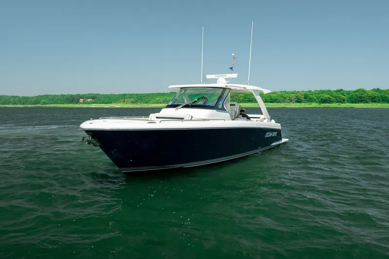 Slide: The Image of 2022 Tiara Yachts 38 LS cruising on a calm, scenic waterway. - 5