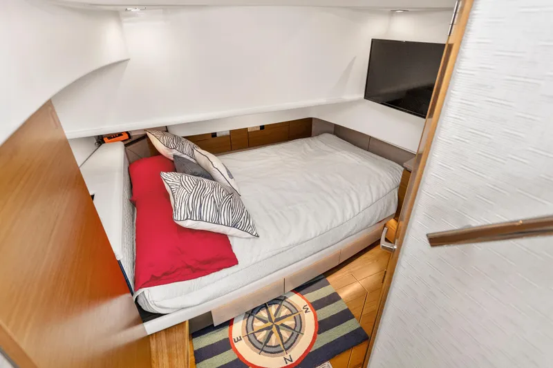 Slide: The Image of Luxurious cabin interior of 2022 Tiara Yachts 38 LS with cozy bed and modern decor. - 26