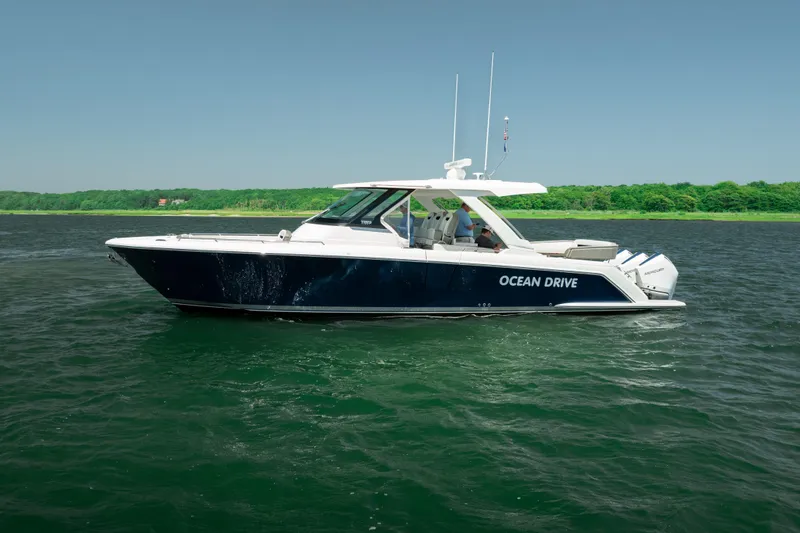 Slide: The Image of 2022 Tiara Yachts 38 LS boat named "Ocean Drive" on water, side view. - 7