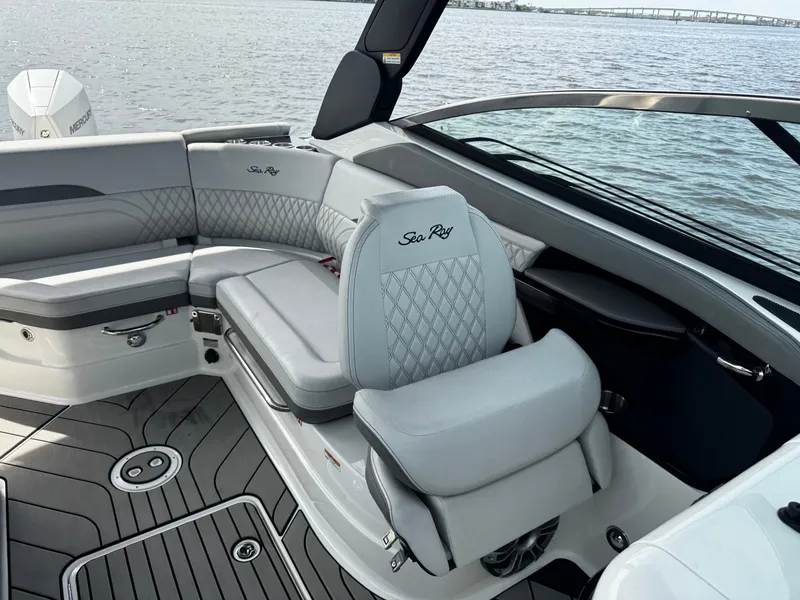 Slide: The Image of The image shows the cockpit of a 2025 Sea Ray SLX 260 Outboard with luxurious seating. - 24