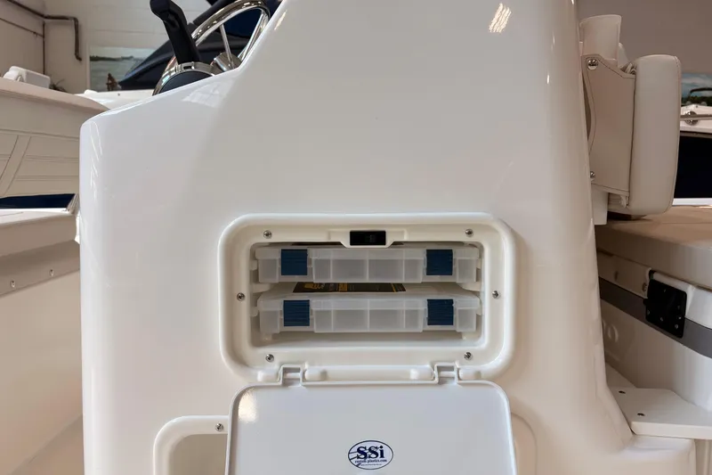 Slide: The Image of 2026 Boston Whaler 190 Montauk boat console with storage compartments and steering wheel. - 14
