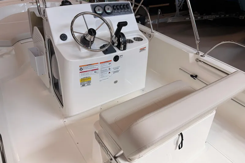Slide: The Image of 2026 Boston Whaler 190 Montauk boat interior with steering console and seating. - 15