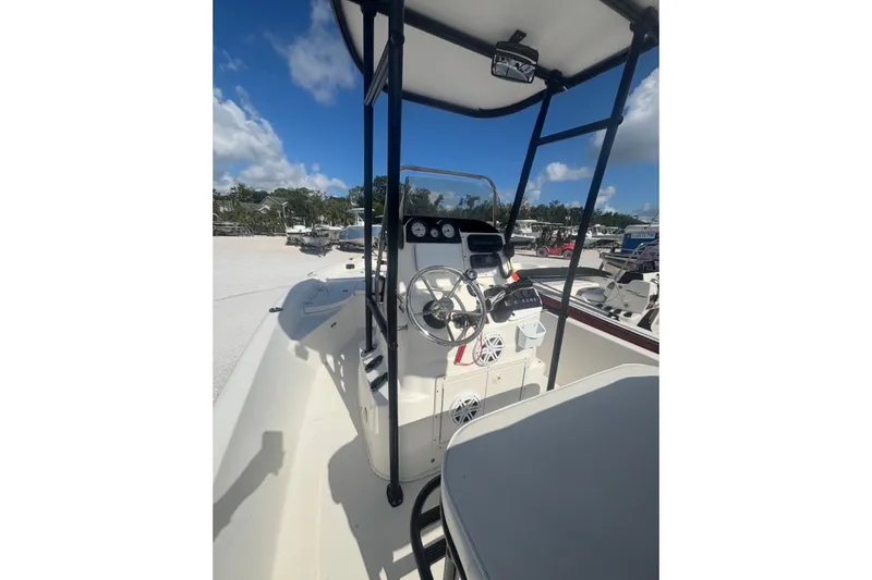 Slide: The Image of 2017 NauticStar 1910 NauticBay boat interior with steering console under clear blue sky. - 3
