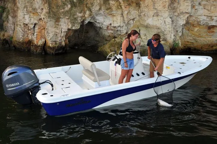 Slide: The Image of Manufacturer Provided Image: 2017 NauticStar 1910 NauticBay boat with Yamaha motor, two people fishing near rocky shore. - 8