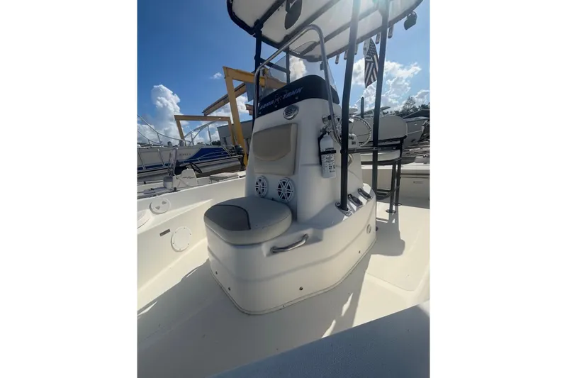 Slide: The Image of 2017 NauticStar 1910 NauticBay boat interior with seating and console under sunny skies. - 5