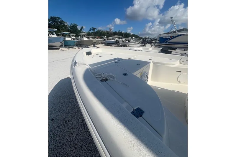 Slide: The Image of 2017 NauticStar 1910 NauticBay boat on gravel lot under blue sky. - 4
