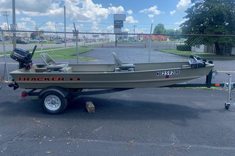 The Image of 2025 Tracker Topper 1436 boat on trailer, parked outdoors under a cloudy sky. - 1
